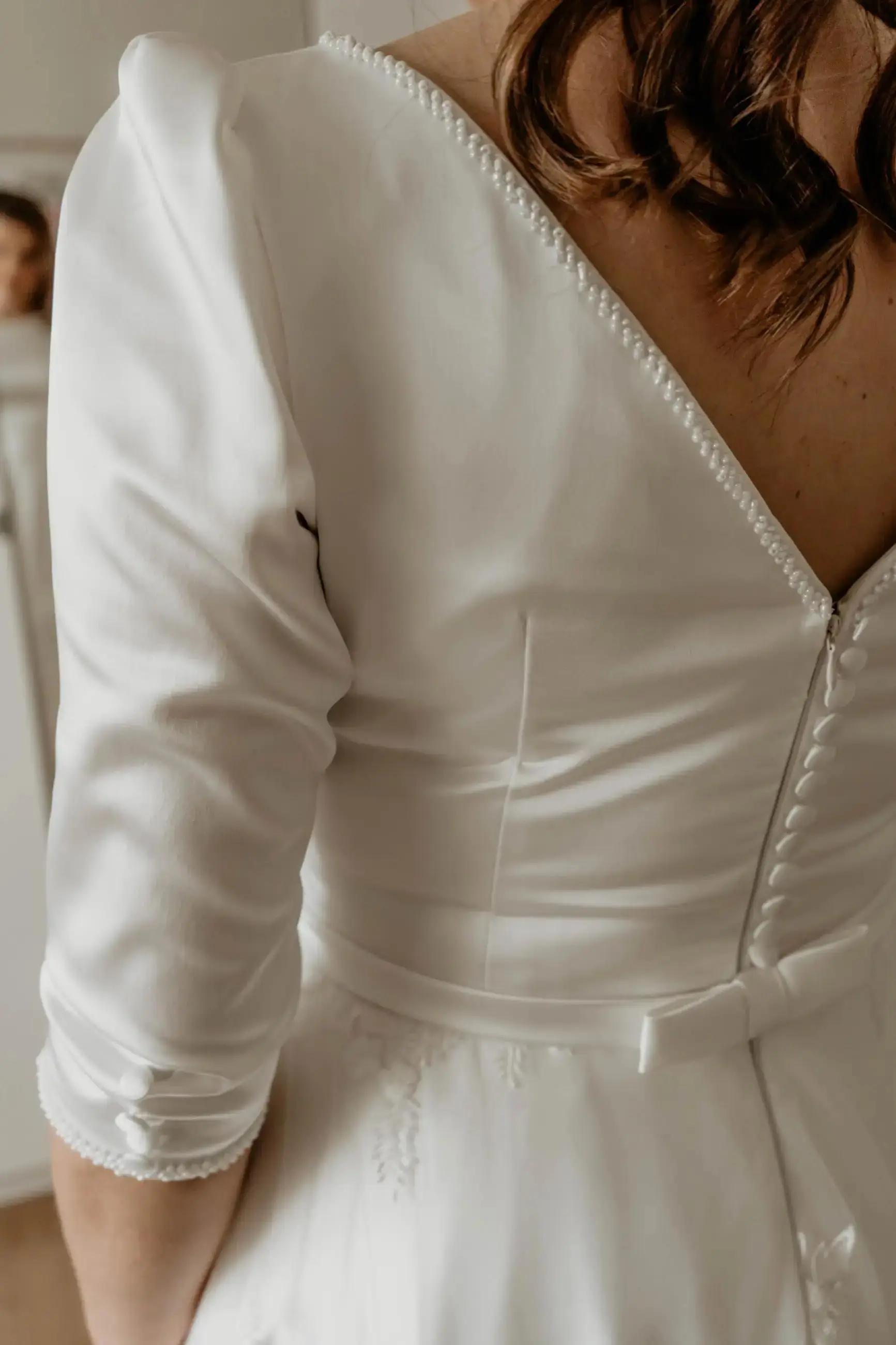 a bride wearing a white weding dress